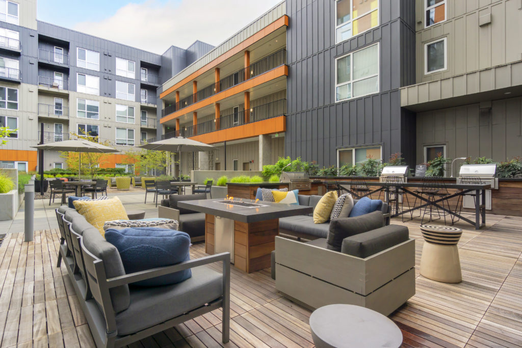 outdoor courtyard with fire table and grills