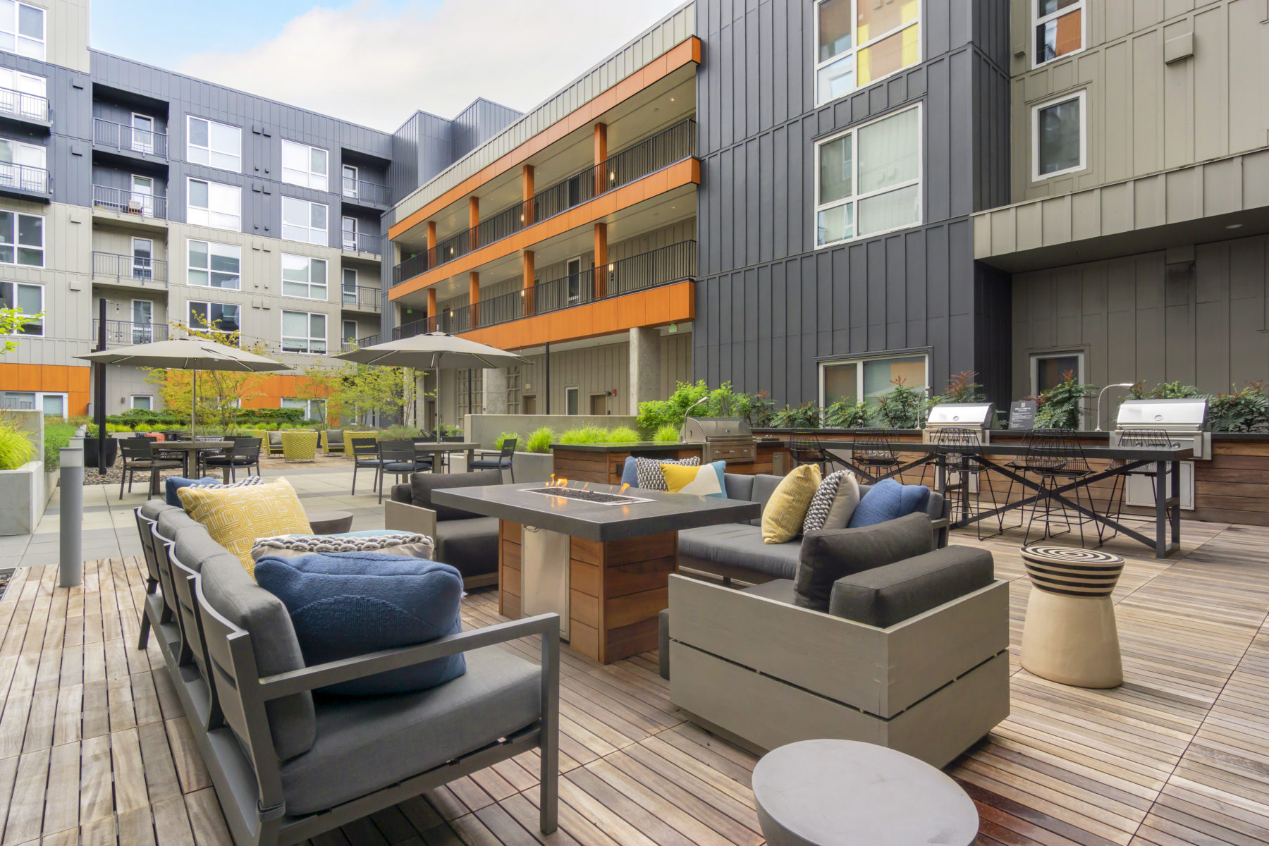 outdoor courtyard with fire table and grills